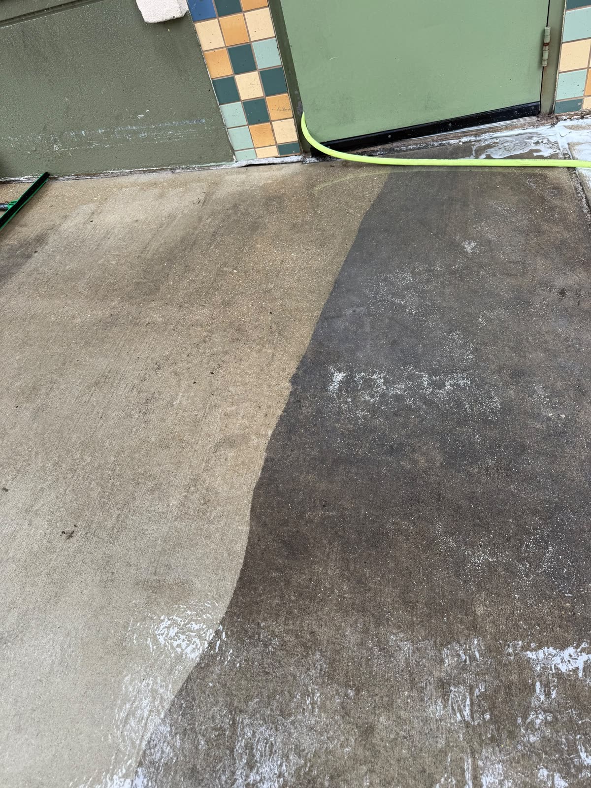 Commercial concrete floor half cleaned: clean on the left, still dirty on the right
