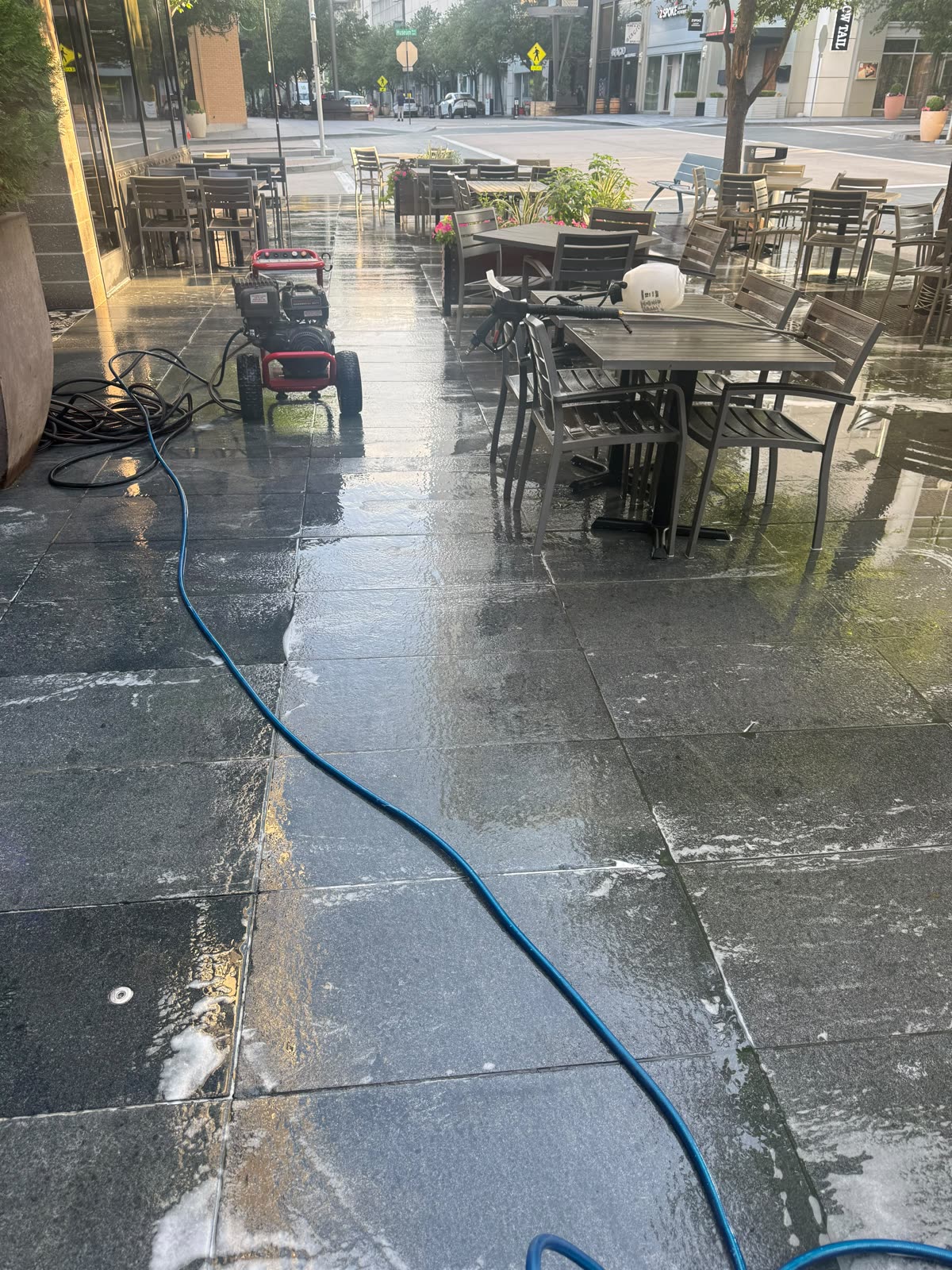 Restaurant patio being pressure washed before opening