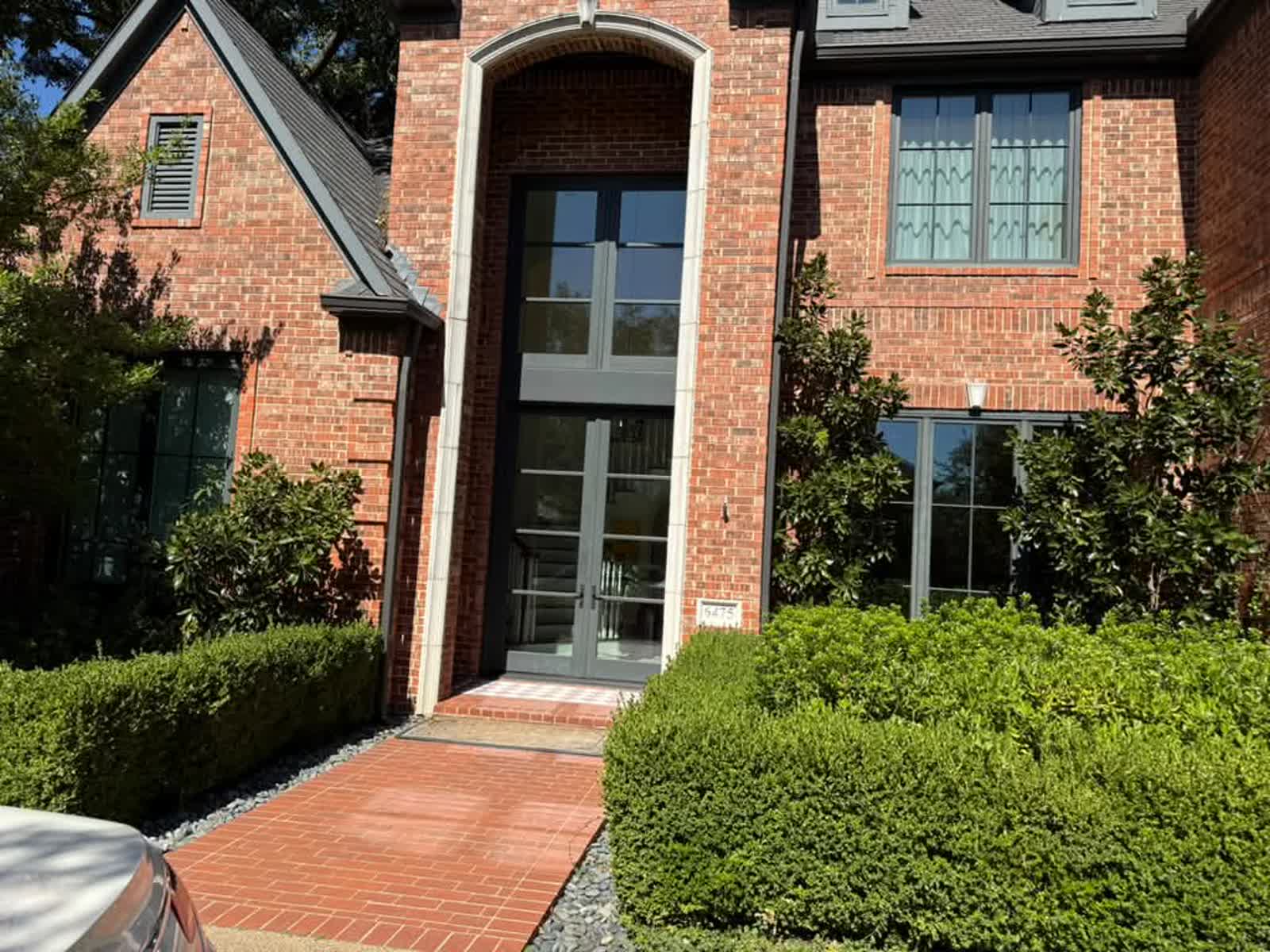 University Park home entrance with clean glass and stone